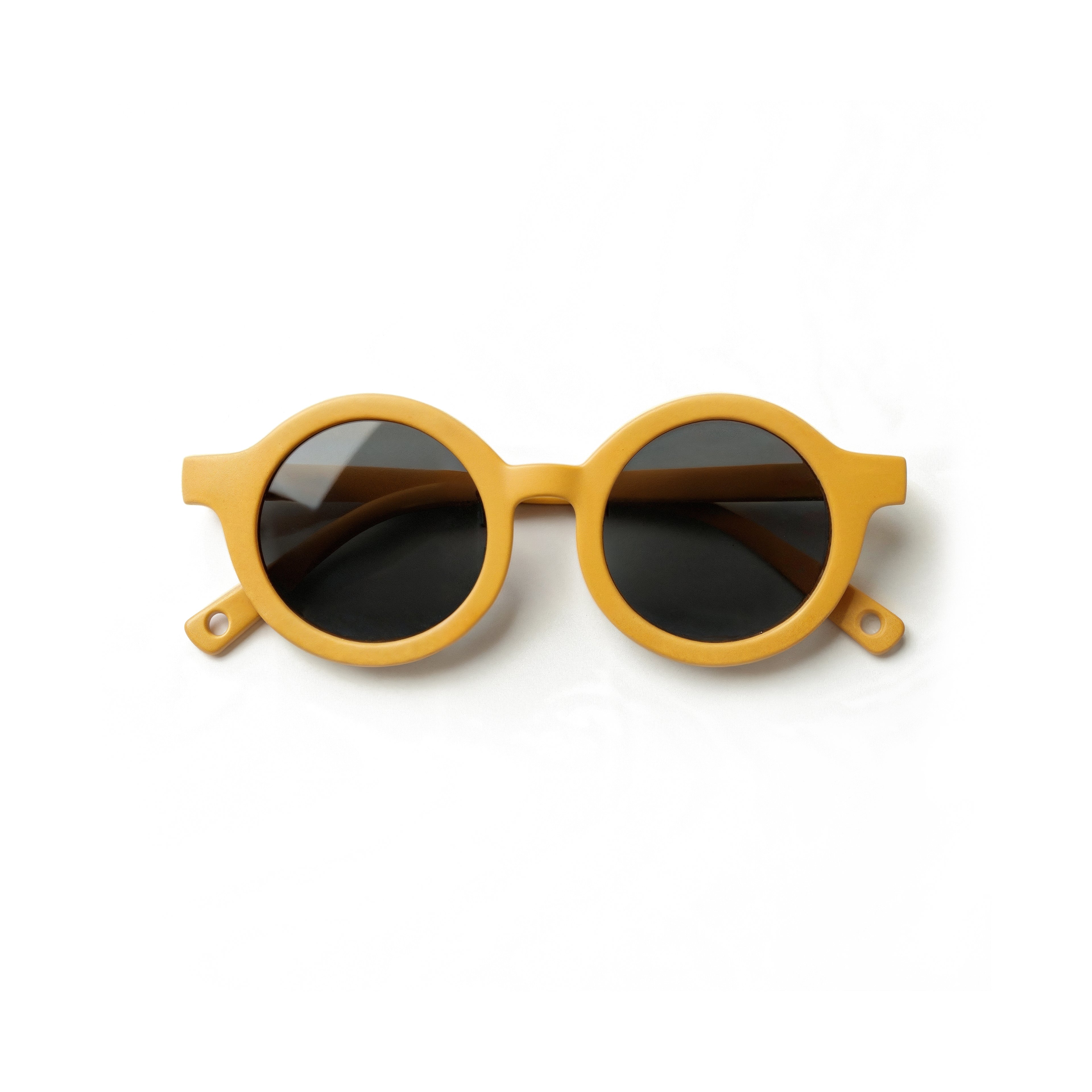 Occhiali da sole zo-oz stile tondo modello Bam giallo opaco per bambini 0-2 anni piegati e fotografati dall'alto.