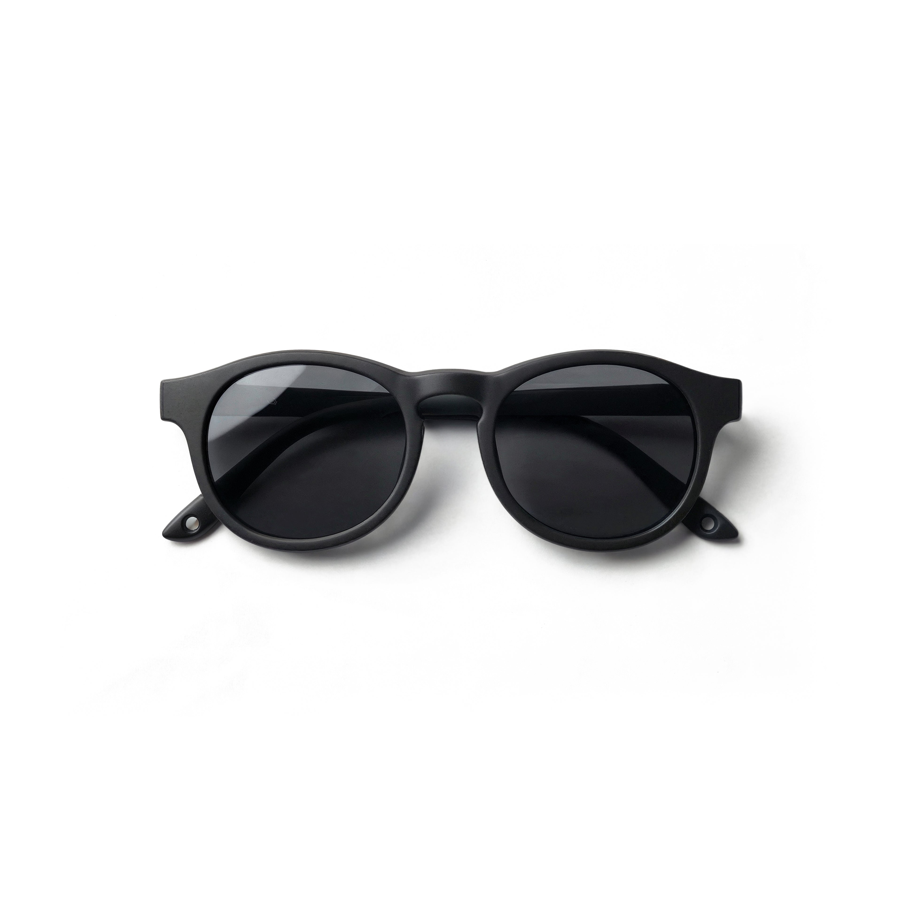 Occhiali da sole zo-oz stile pantos modello Pop nero opaco per bambini 0-2 anni piegati e fotografati dall'alto.