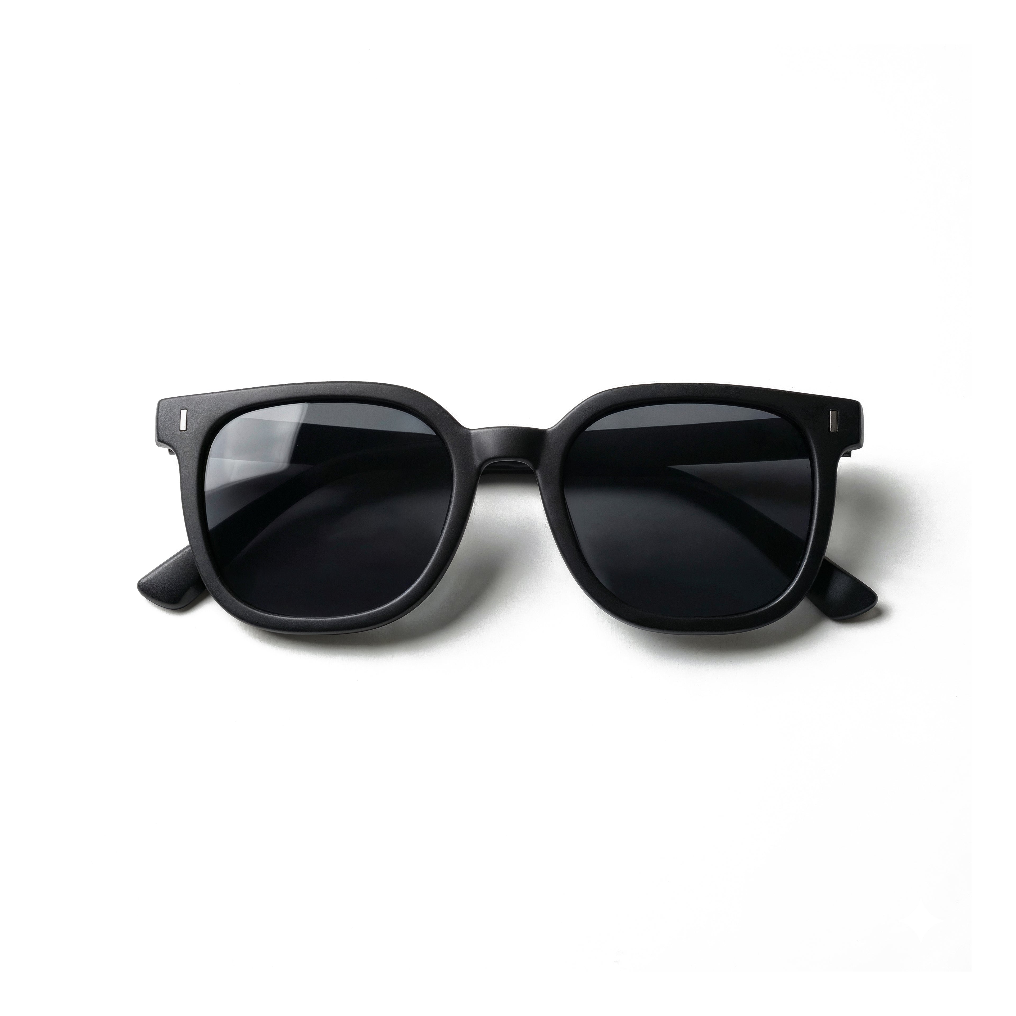 Occhiali da sole zo-oz stile wayfarer modello Zip nero opaco per bambini 6-12 anni piegati e fotografati dall'alto.